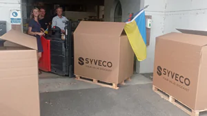 Donations in large SYVECO-labelled boxes on pallets, ready to be shipped to Ukraine for people in need.