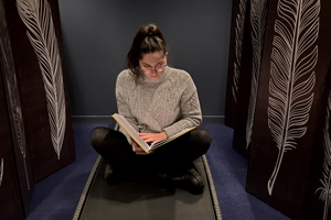 young woman reading on a deckchair in a rest room, calm atmosphere
