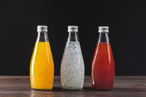 three bottles of coloured soft drinks, referring to food industry