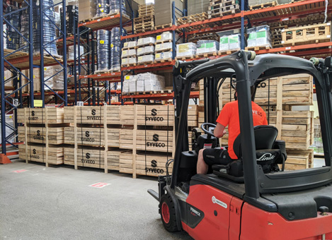 an employee driving a forklift in the Syveco warehouse